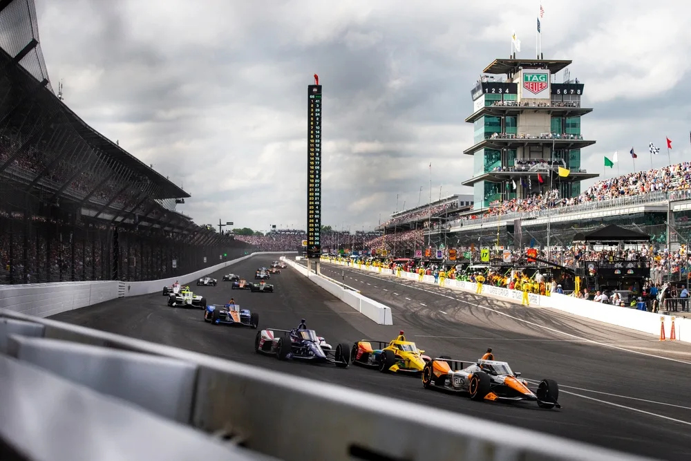 Photo of race cars driving around the speedway in Indy during the Indy 500, the overall best time to visit Indianapolis